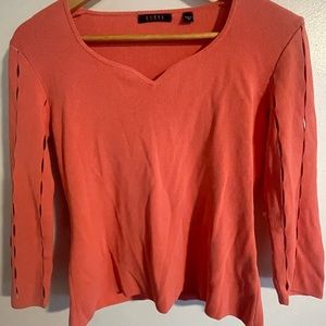 Medium sweater with cut outs in both sleeves.